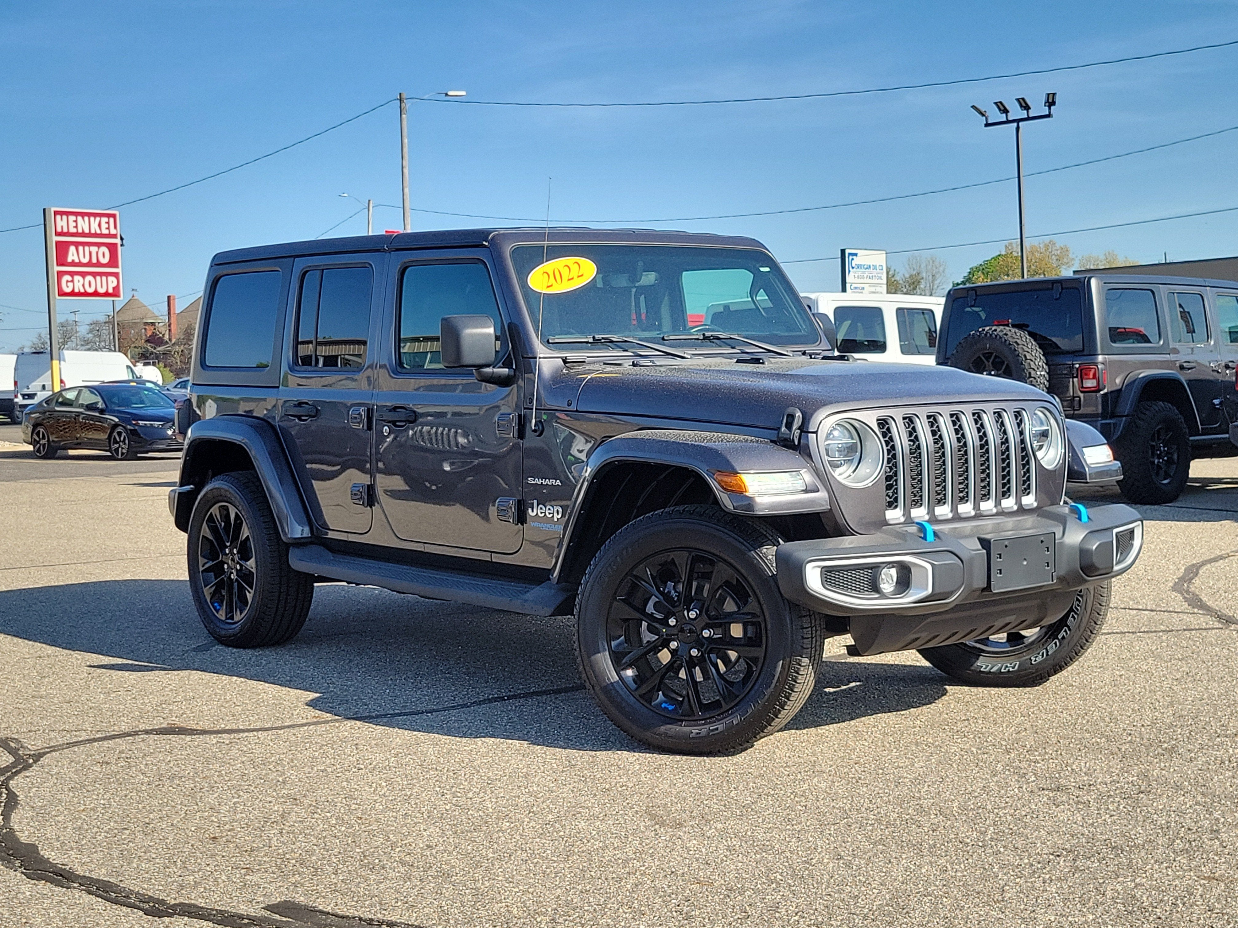 2022 Jeep Wrangler 4xe Unlimited Sahara 4x4 in Granite Crystal Metallic Clearcoat — front three-quarter view