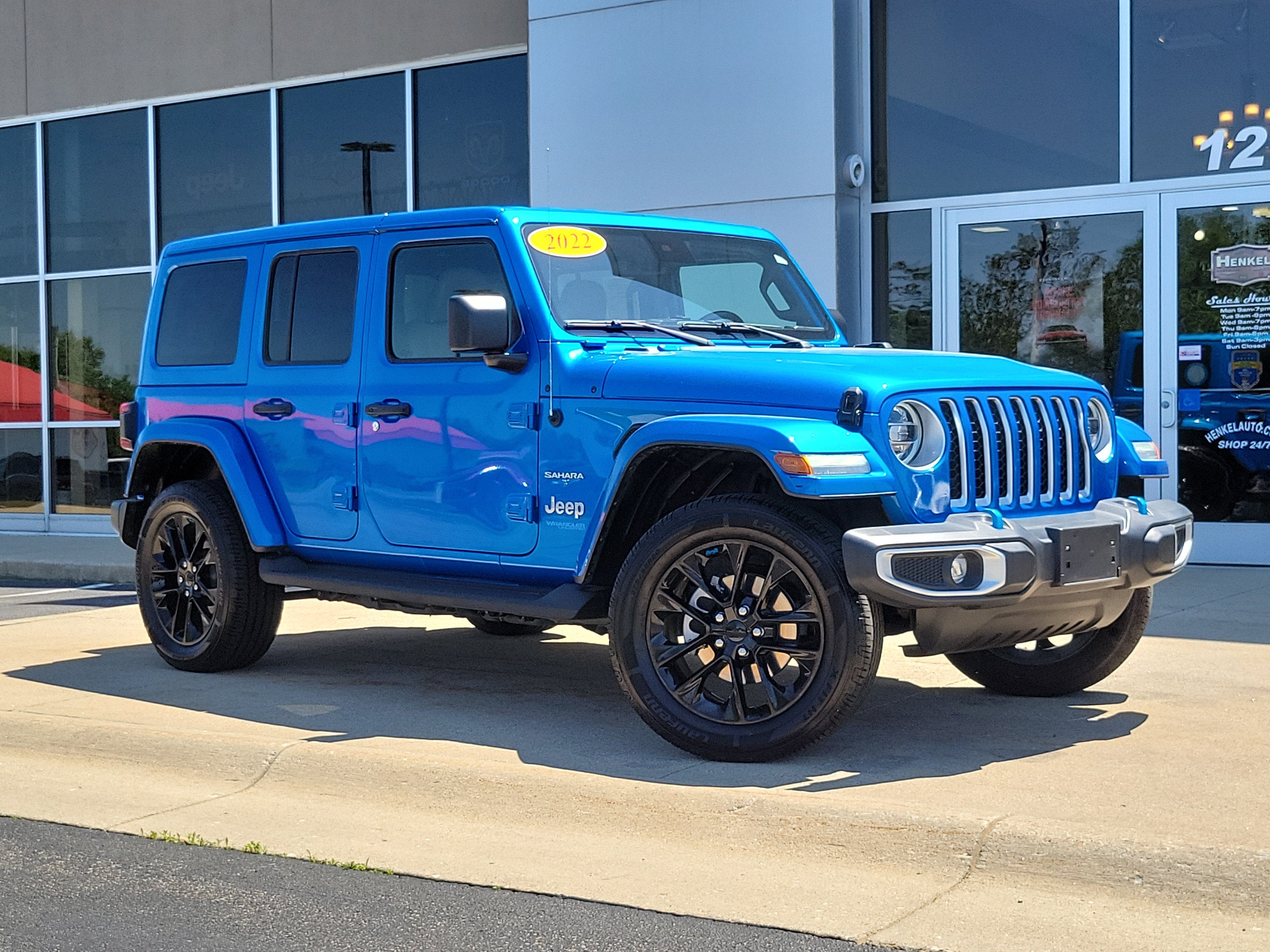2022 Jeep Wrangler 4xe Unlimited Sahara 4x4 in Hydro Blue Pearlcoat — front three-quarter view