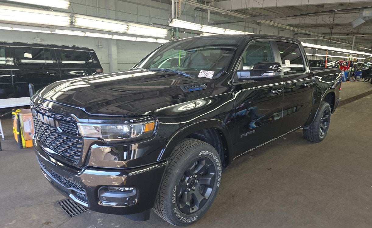 2025 RAM 1500 Big Horn Crew Cab 4x4 5'7' Box in Diamond Black Crystal Pearlcoat — front three-quarter view