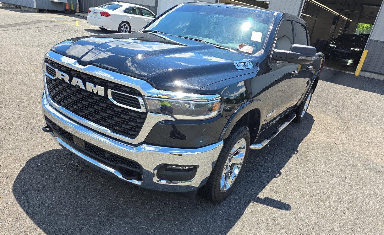 2025 RAM 1500 Lone Star Crew Cab 4x4 5'7' Box in Diamond Black Crystal Pearlcoat — front three-quarter view