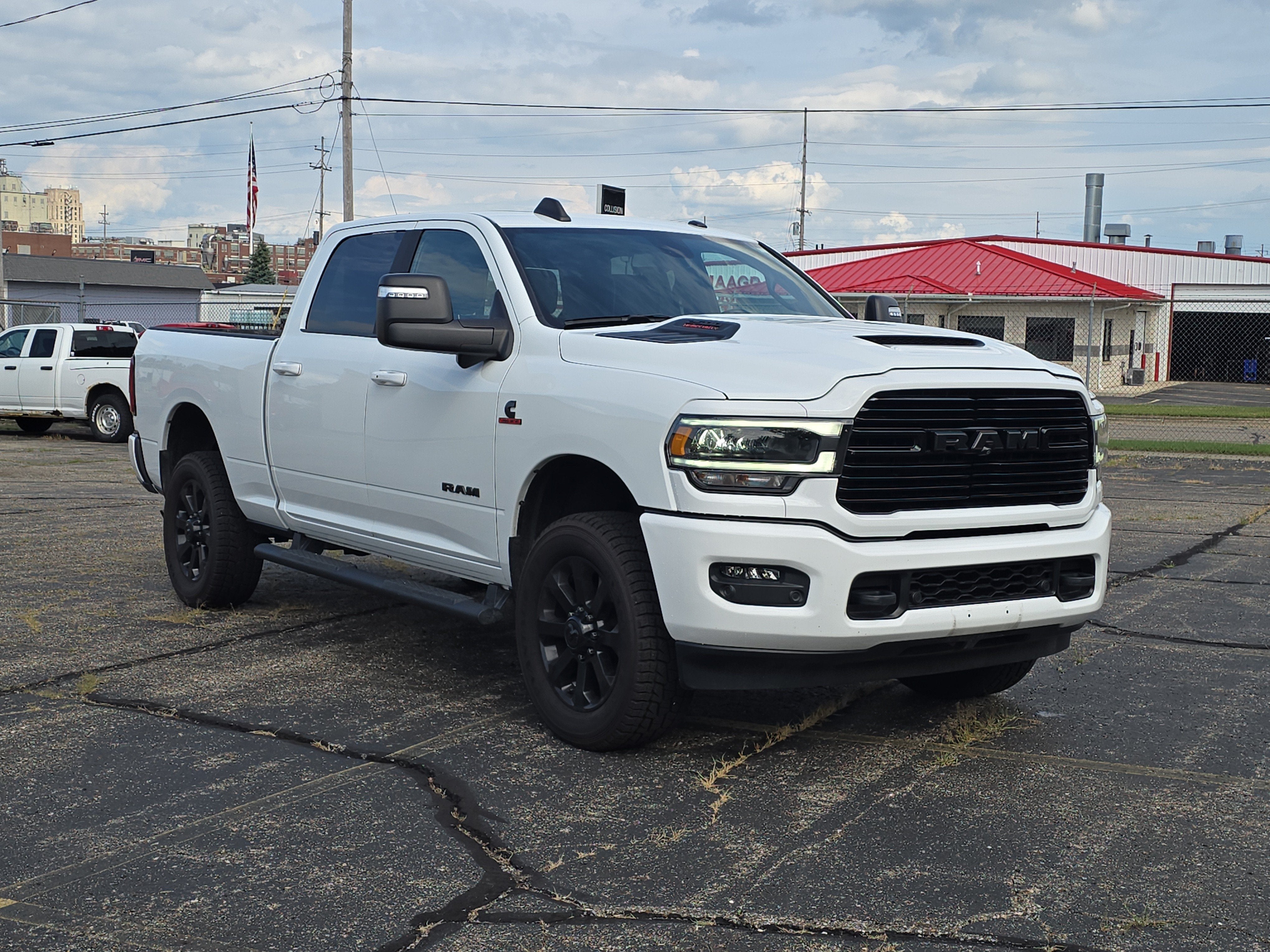 2023 RAM 2500 Laramie Crew Cab 4x4 6'4' Box in Bright White Clearcoat — front three-quarter view